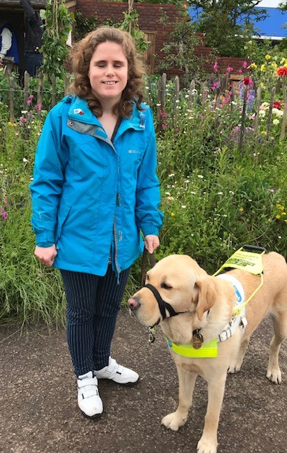 Harriet with guide dog Sparky in a garden