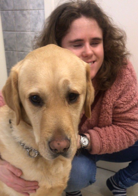 Harriet cuddling guide dog Sparky