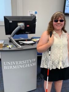 Emma next to a University of Birmingham sign