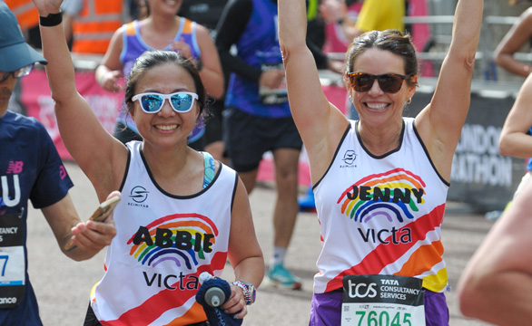 ballot-runners-feature-1 Two femail runners in VICTA vests raise their arms as they run